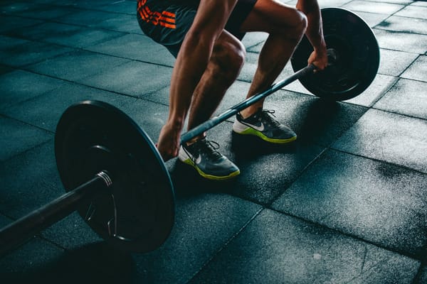Athlete training with weights in a gym